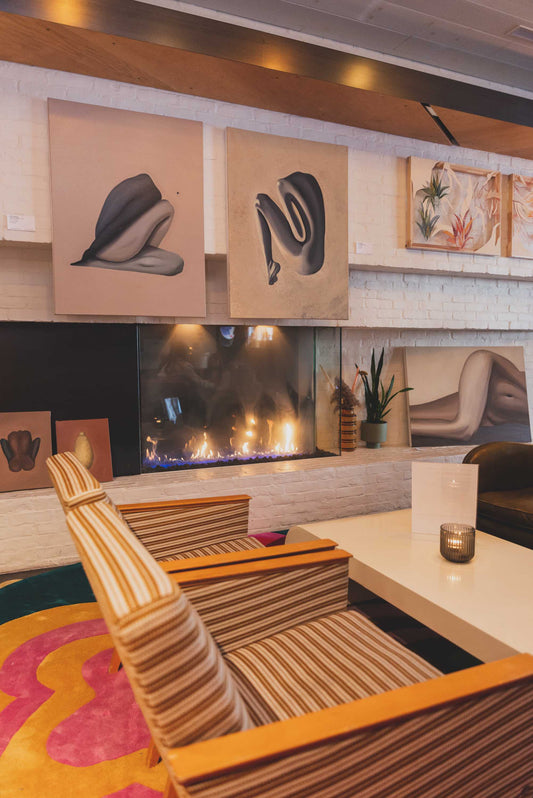 Blue female figure with a beige background pictured in a exhibition