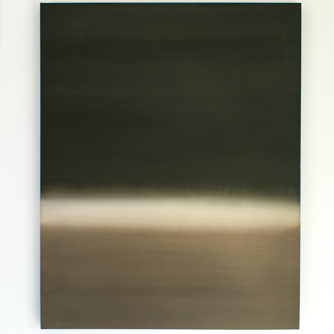 Abstract neutral and green artwork on the wall