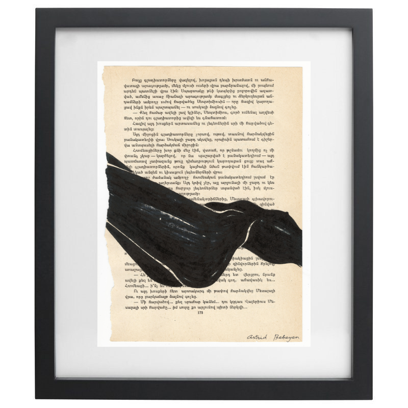 Minimalist artwork of a female form on top of a page of a book in a black frame