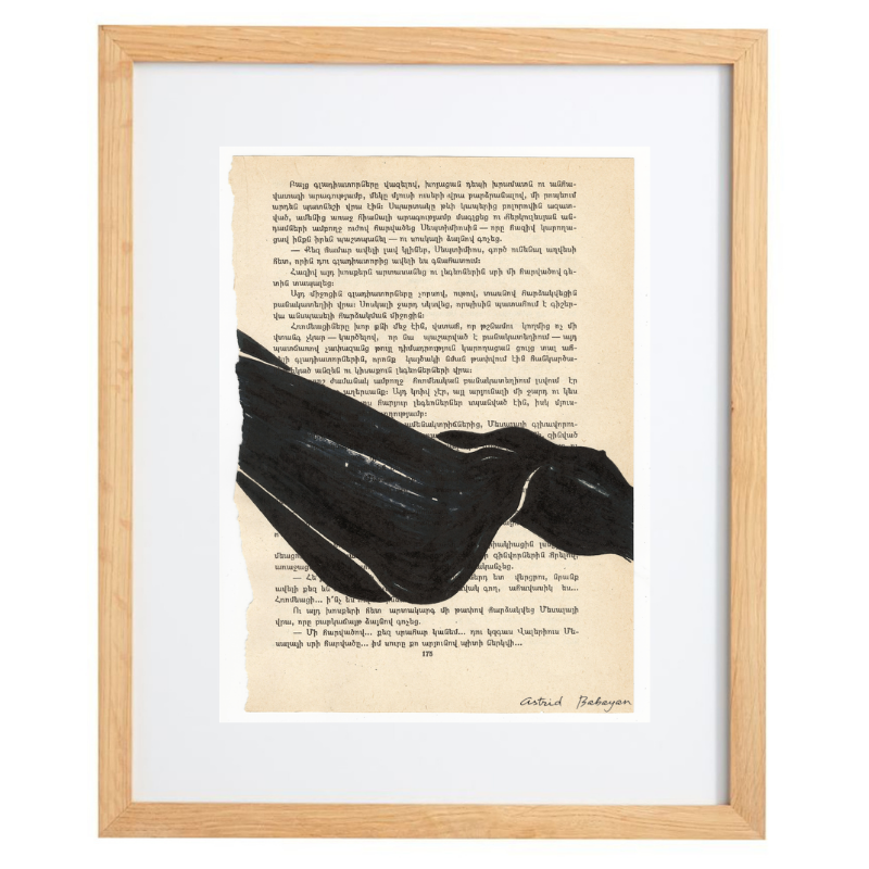 Minimalist artwork of a female form on top of a page of a book in a natural frame