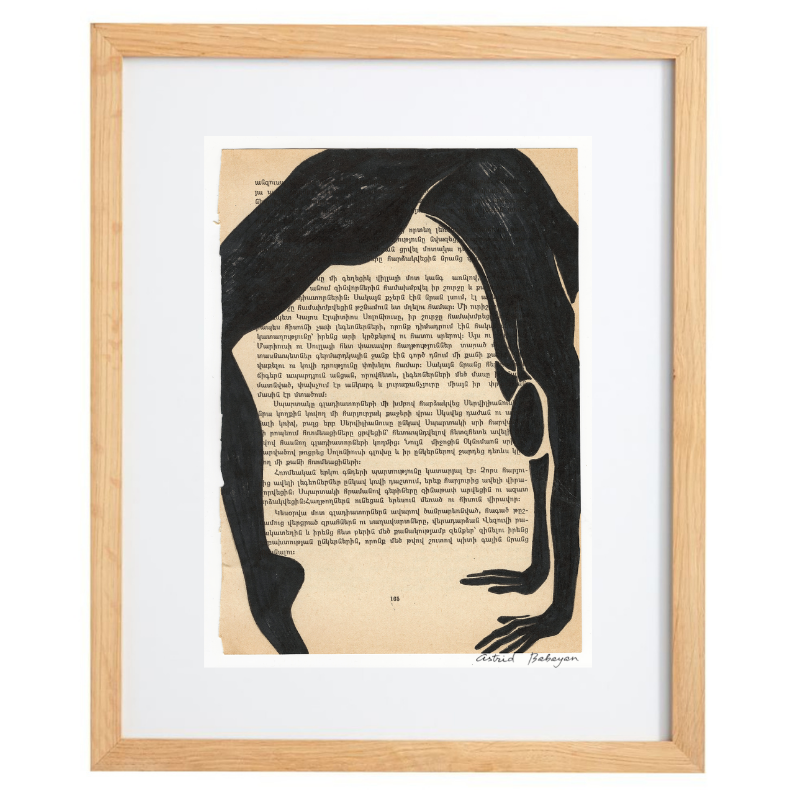 Minimalist artwork of a female form on top of a page of a book in a natural frame