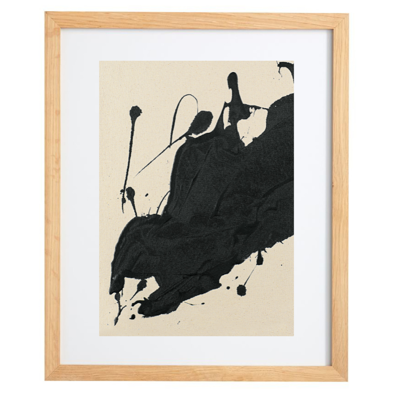 Abstract black paint splatter artwork in a natural frame