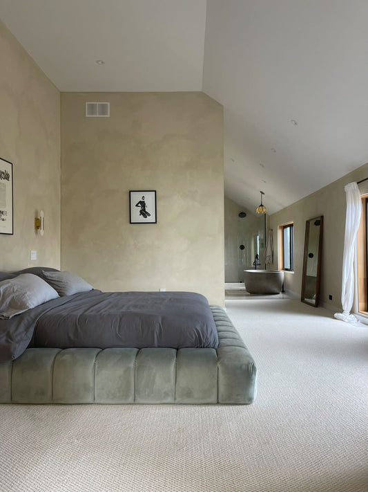 Minimalist female figure in black and white pictured in a bedroom