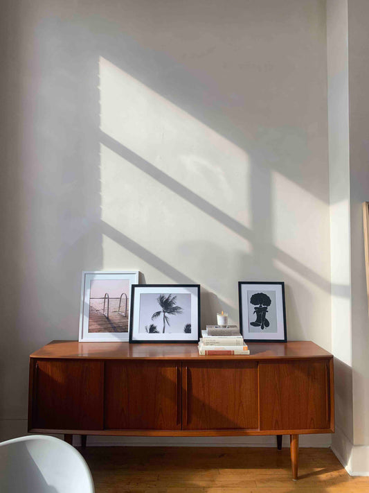 Palm tree blowing in the wind photography pictured on a credenza