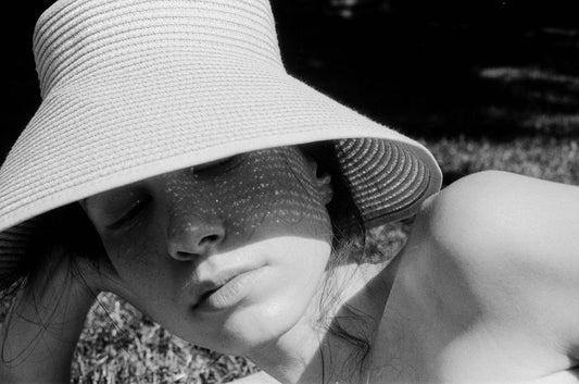 Photograph of a woman laying on the beach