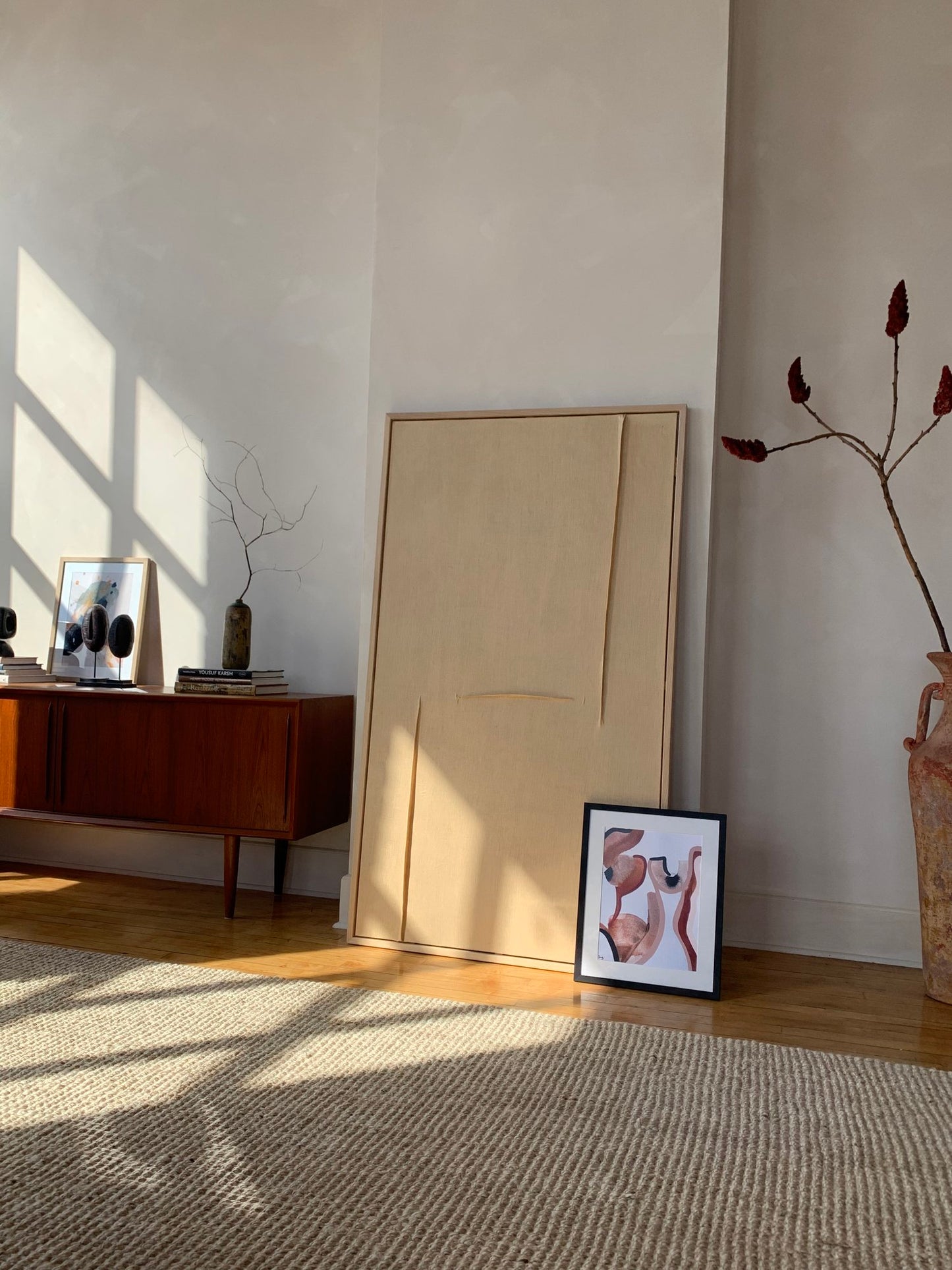 Abstract pinks and browns artwork pictured leaning against the wall