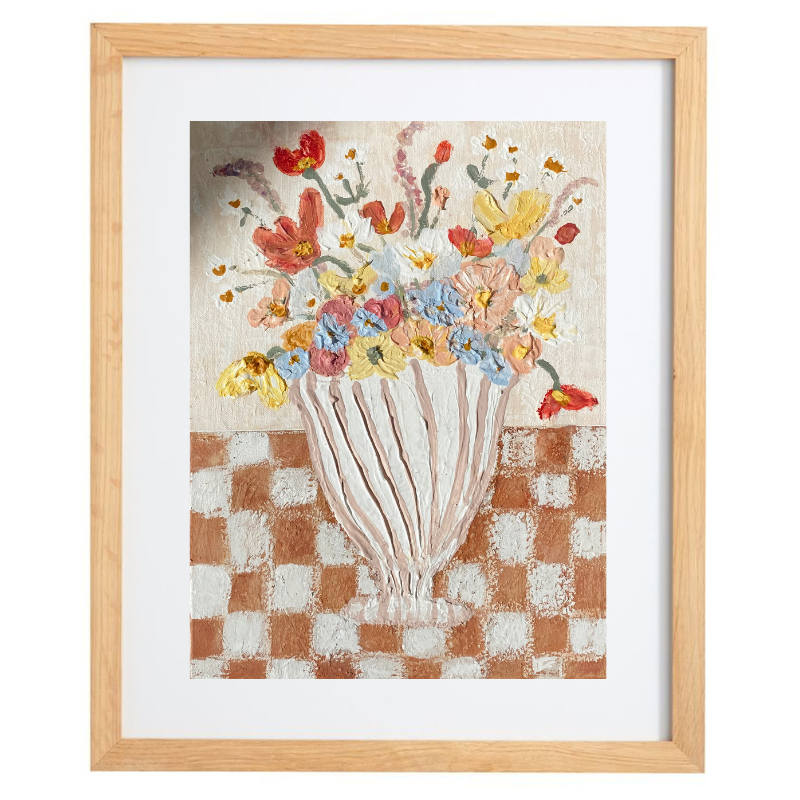 Abstract striped vase with flowers on a checkered table in a natural frame
