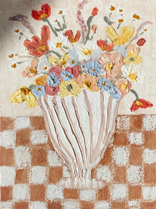 Abstract striped vase with flowers on a checkered table 