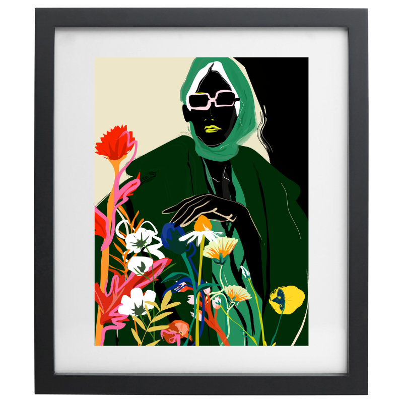 Woman in a green outfit with florals artwork in a black frame