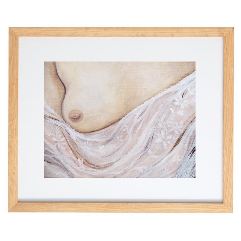 Exposed breast with lace artwork in a natural frame 