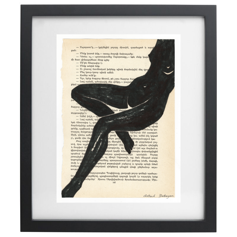 Minimalist artwork of a female form on top of a page of a book in a black frame