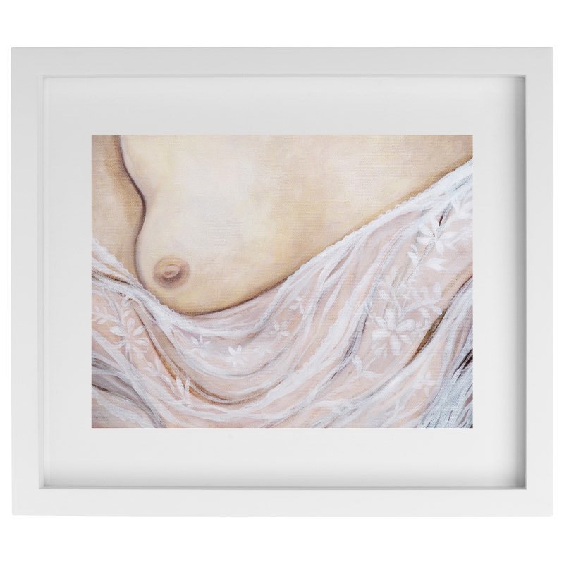 Exposed breast with lace artwork in a white frame