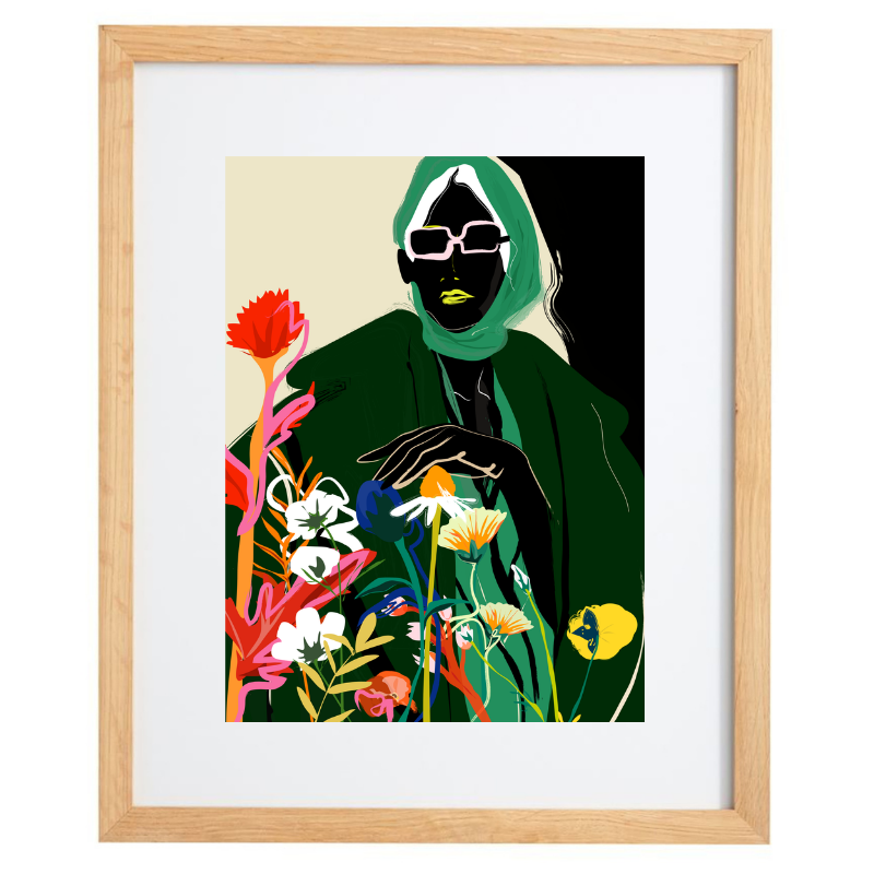 Woman in a green outfit with florals artwork in a natural frame