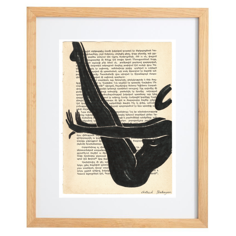 Minimalist artwork of a female form on top of a page of a book in a natural frame