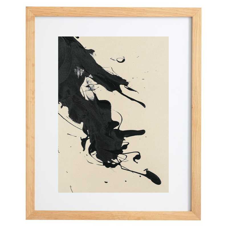 Abstract black paint splatter artwork in a natural frame