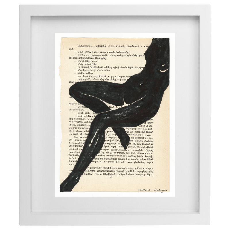 Minimalist artwork of a female form on top of a page of a book in a white frame