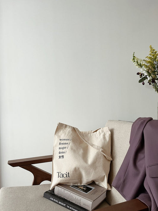 Tacit Collective's Woman canvas tote pictured on a chair