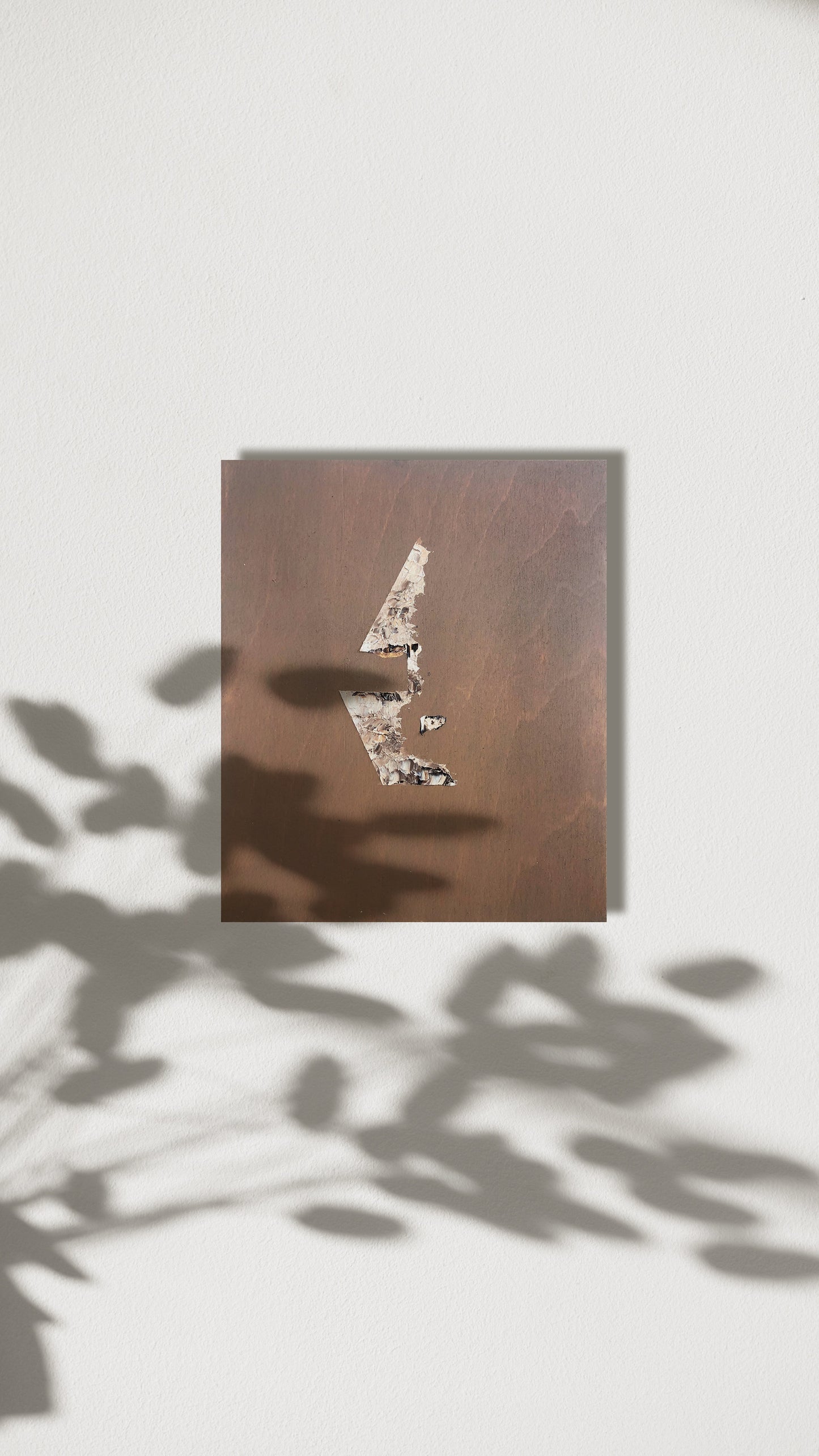 Abstract figure artwork in a neutral palette pictured on the wall