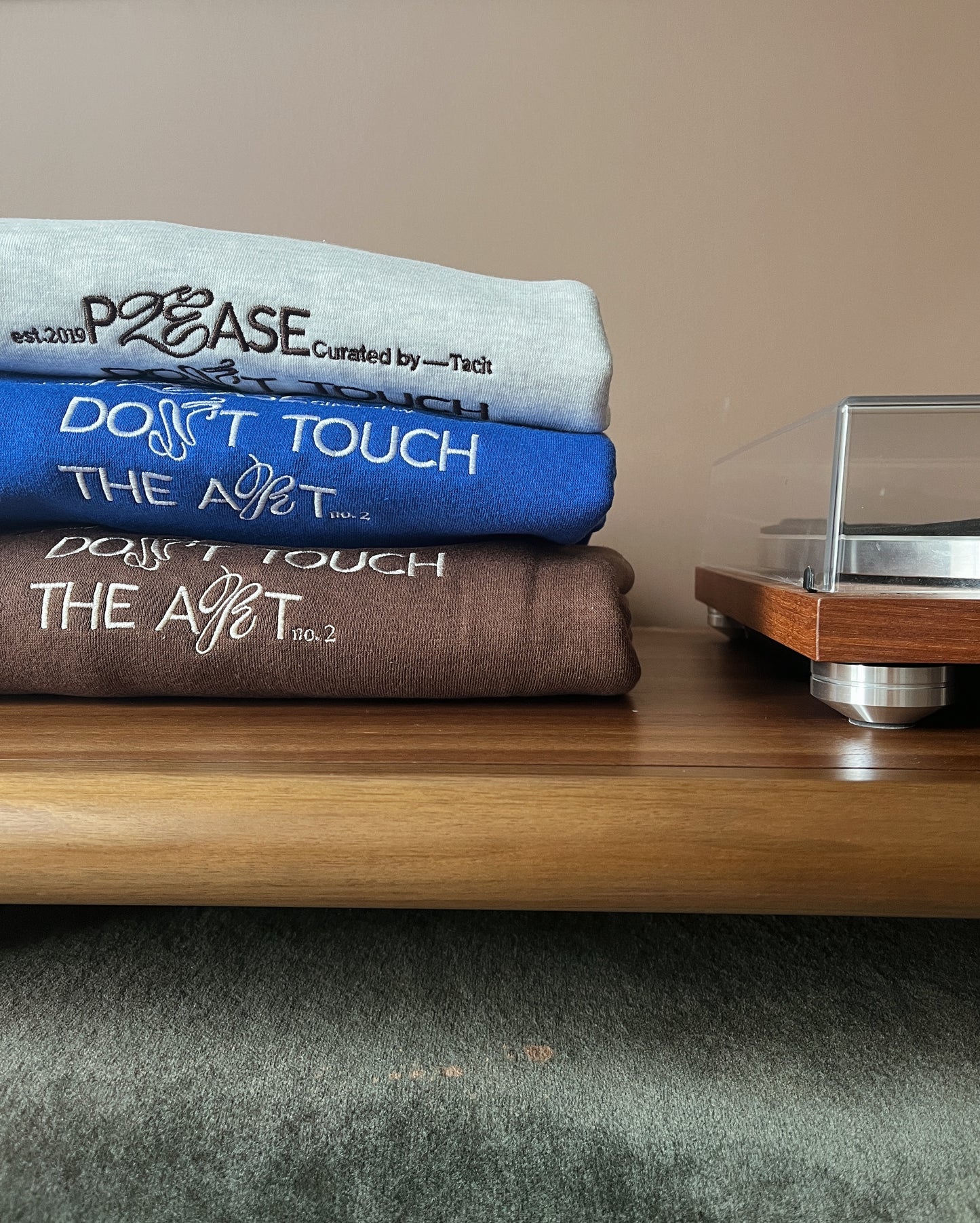 Tacit's "Please Don't Touch the Art" crewnecks folded