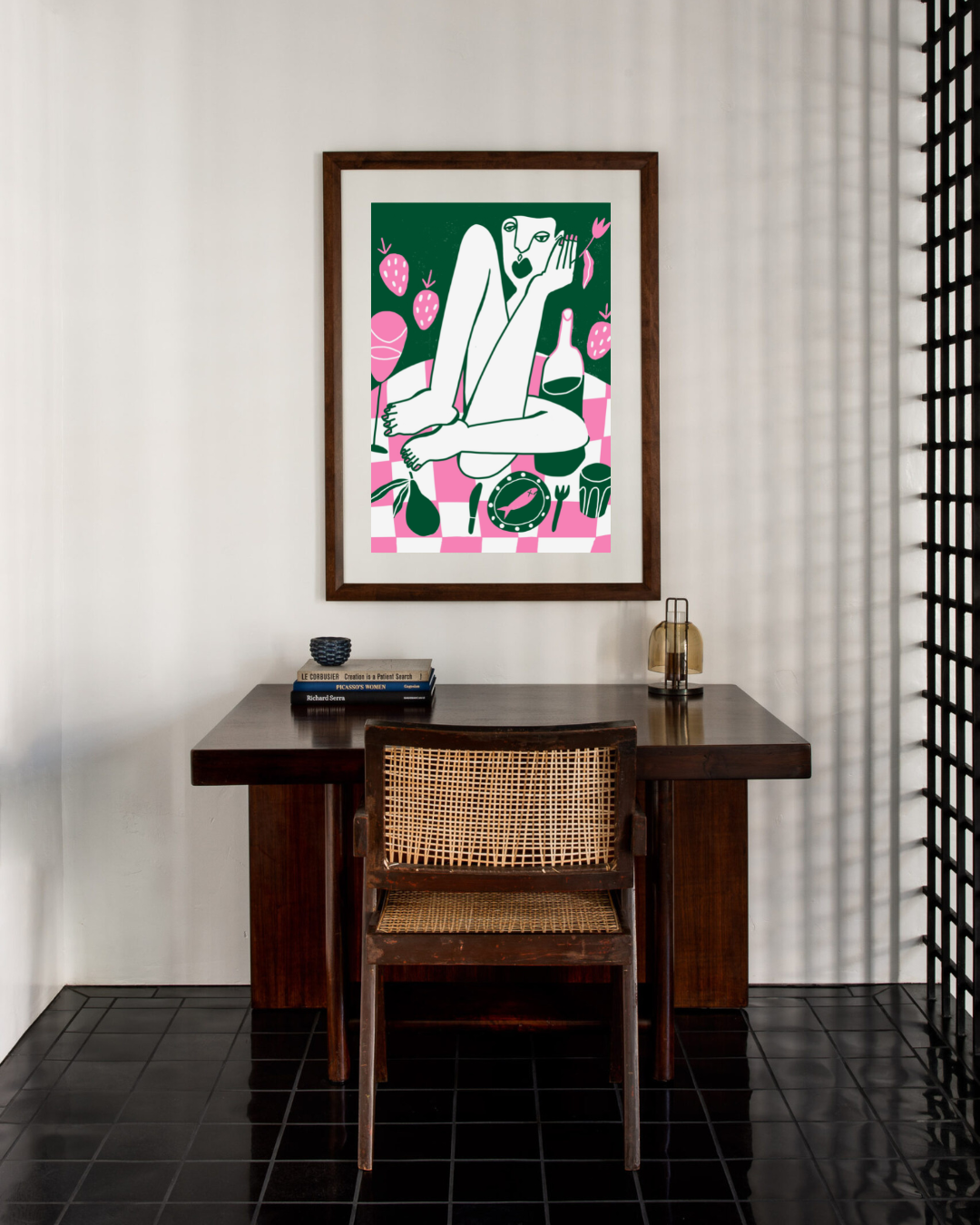 Green and pink abstract artwork pictured above a desk