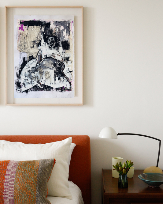 Abstract mixed media human figure artwork with a pop of colour pictured above a bed