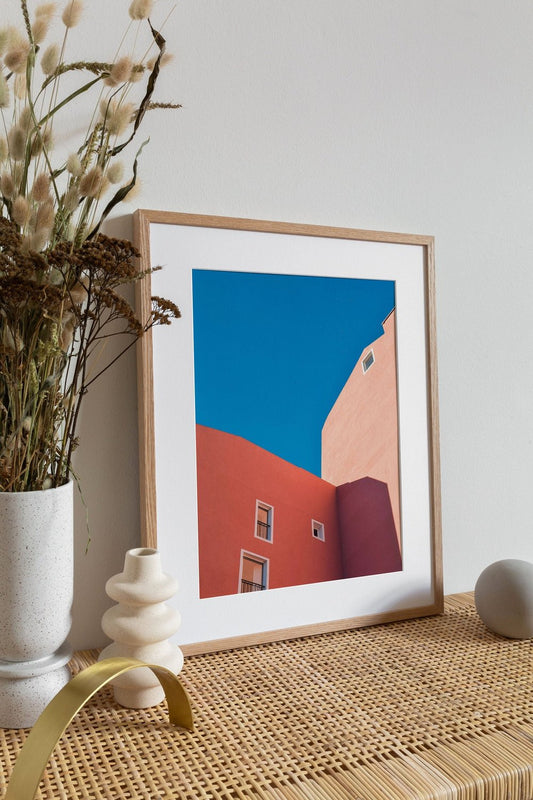 Orange buildings with blue skies photography pictured leaning against the wall